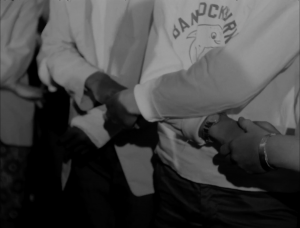 A black and white image shows people with hands interlocked.