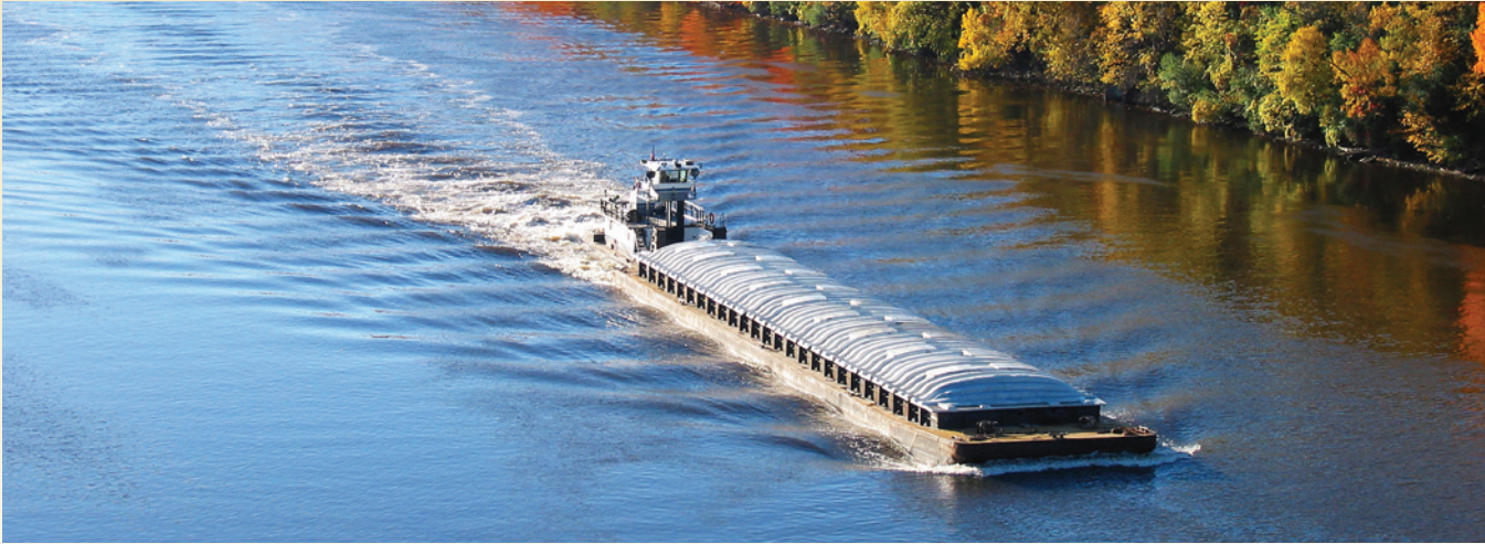 A barge traveling down a waterway.