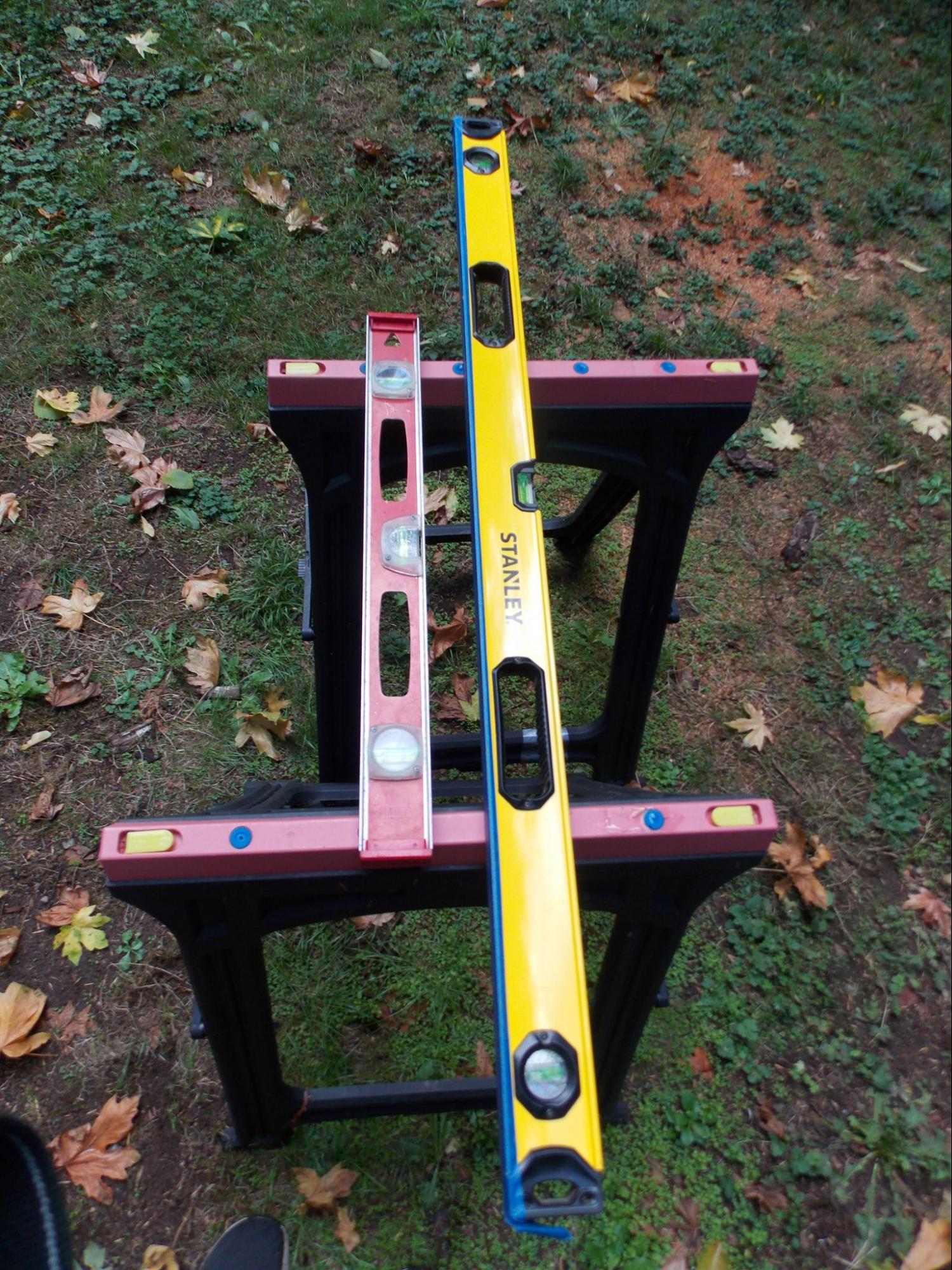 A two-foot and four-foot level sitting across two saw horses.