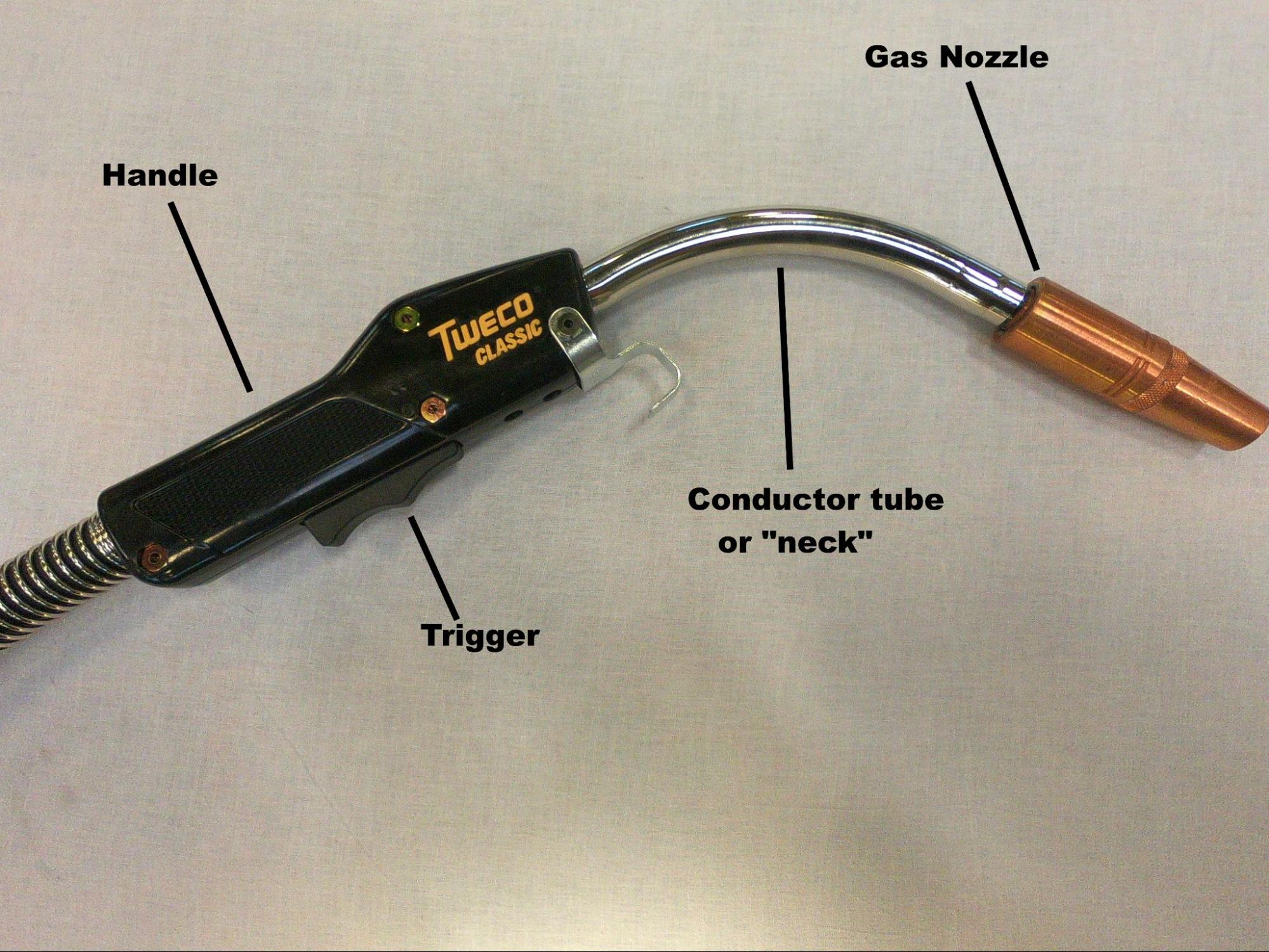 A fully assembled welding gun with major components labeled. Components are labeled and include handle, trigger, conductor tube or “neck,” and gas nozzle.
