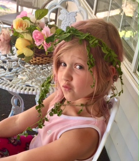 Image a of young girl with an ivy headband.
