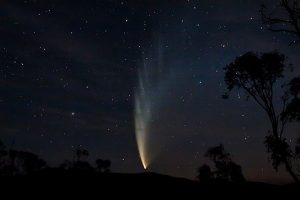The image depicts Comet C/2006 P1 McNaught, a bright comet that became visible to the naked eye in the southern hemisphere during its 2007 perihelion passage. This photograph captures the comet's impressive tail and bright coma against the dark sky. Comet McNaught was one of the brightest comets visible from Earth in recent decades and gained widespread attention and observation due to its brightness and striking appearance.