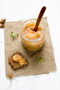 Jar of applesauce with a spoon