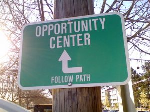sign that reads "Opportunity Center Follow Path" with an arrow