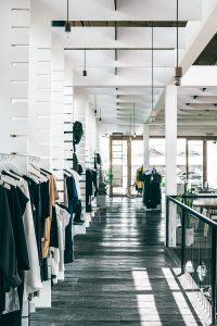 Image of clothing store with clothing items on hangers