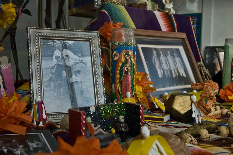 Day of the Dead Altar with photos of the dead, candles and other amulets