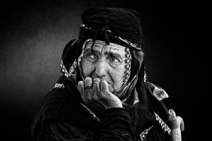 A grieving woman with her face resting on her hand