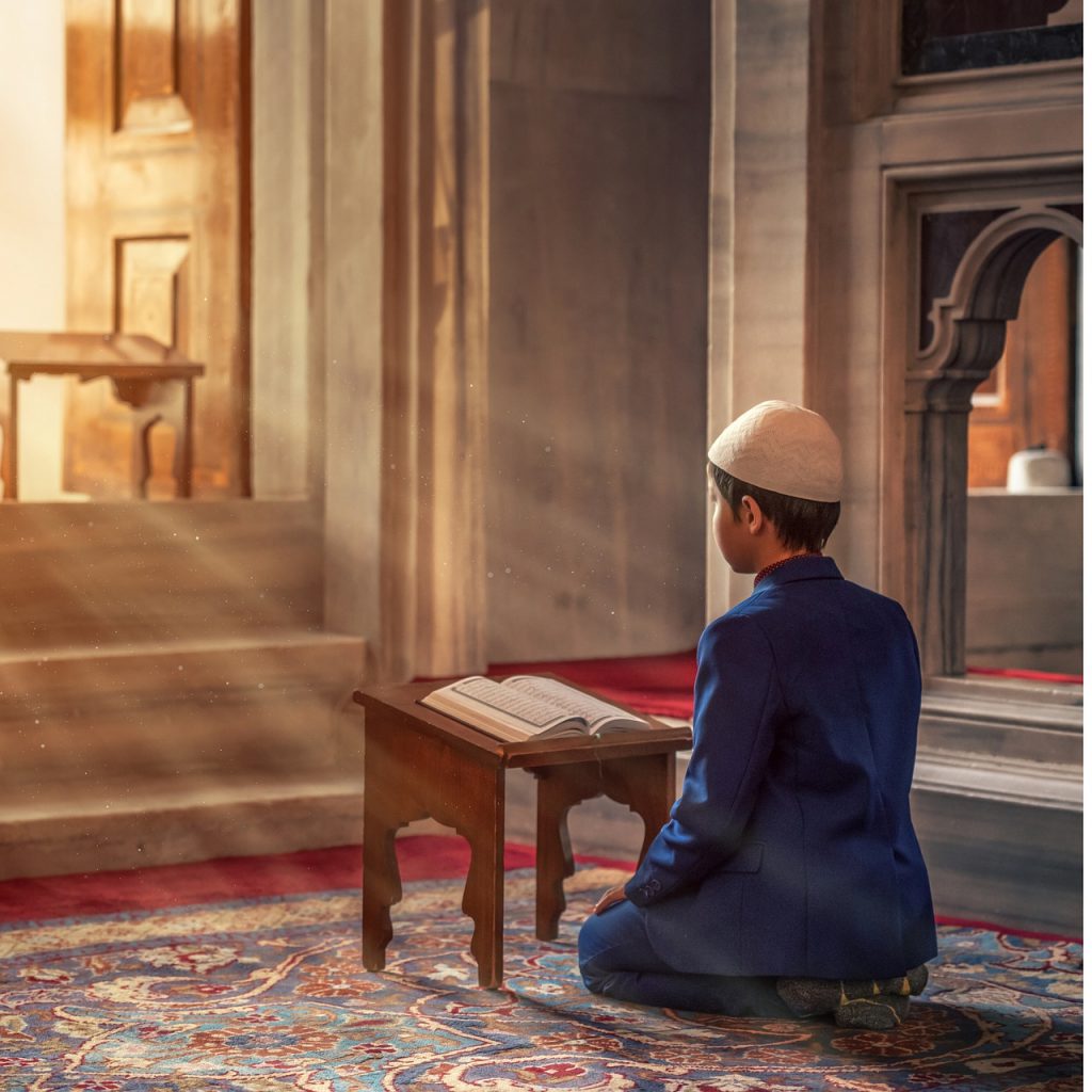 Muslim boy reading Quran