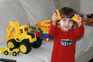 A boy playing with trucks