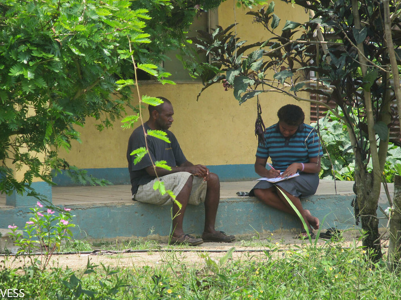 Man writing in notebook during interview