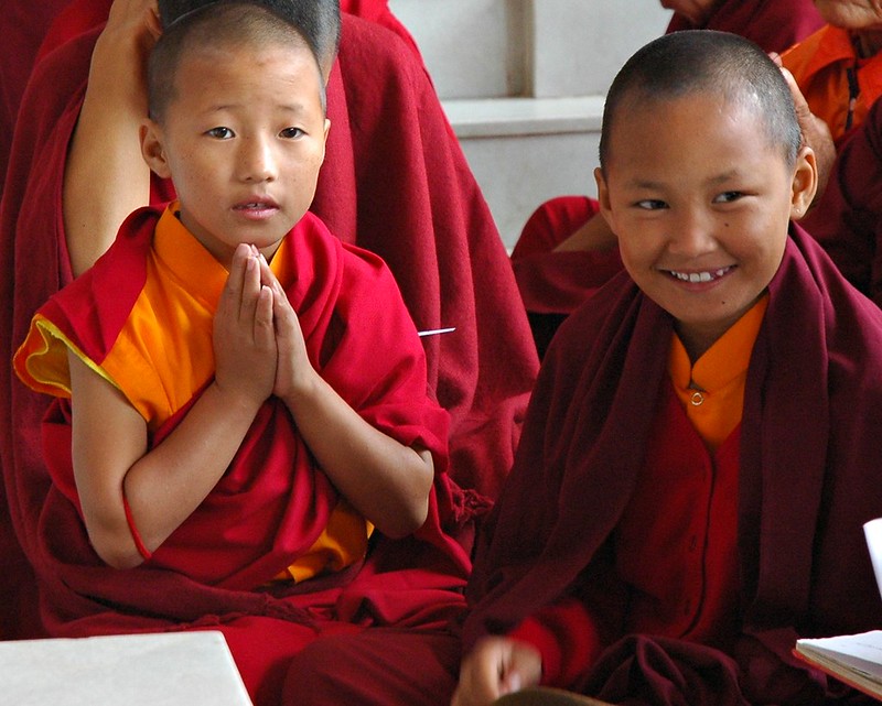 Young monks at the front door of Tharlam Monastery, Boudha, Kathmandu, Nepal