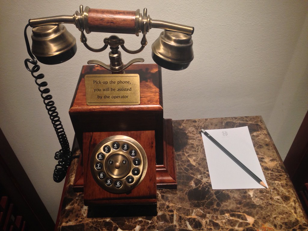 Old-fashioned telephone with comma-spliced instructions